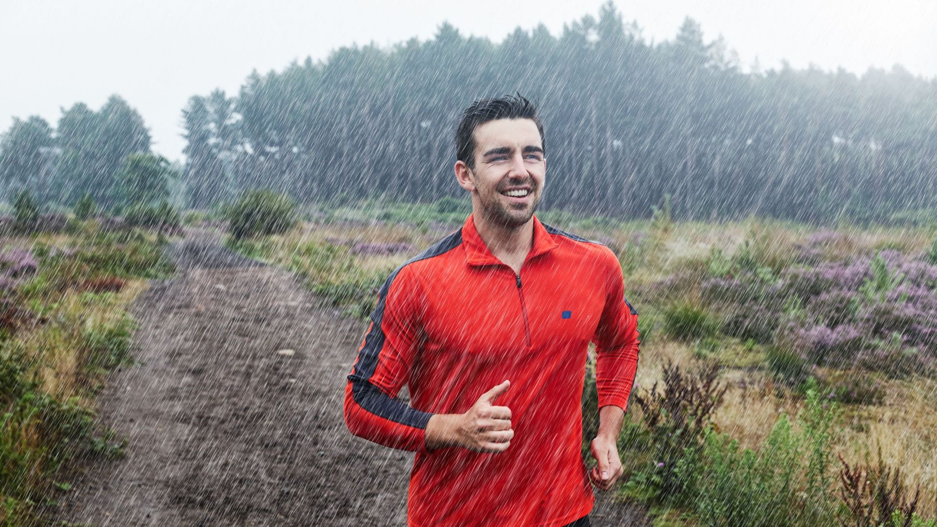 Jogger running on path in rain.