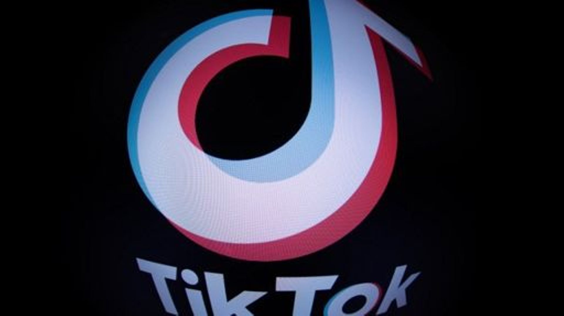 This photograph taken with a fish-eye lens in Paris on March 1, 2023 shows the social media application logo TikTok. The European Parliament has told staff on March 1, 2023 to purge TikTok from devices used for work because of data protection concerns, af