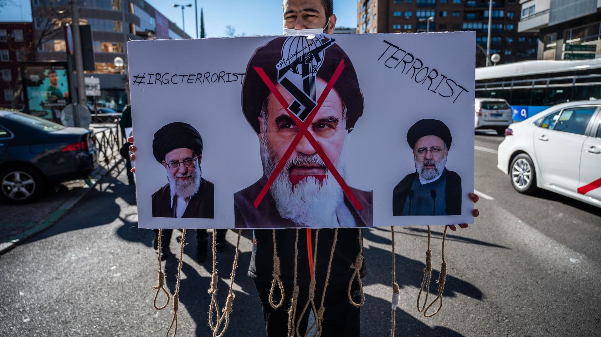 A man protesting carrying placard with 'hanging' ropes during a demonstration against executions and human rights violations in Iran marching to the Iranian embassy in Madrid. The Iranian community has carried out a protest against the executions that are