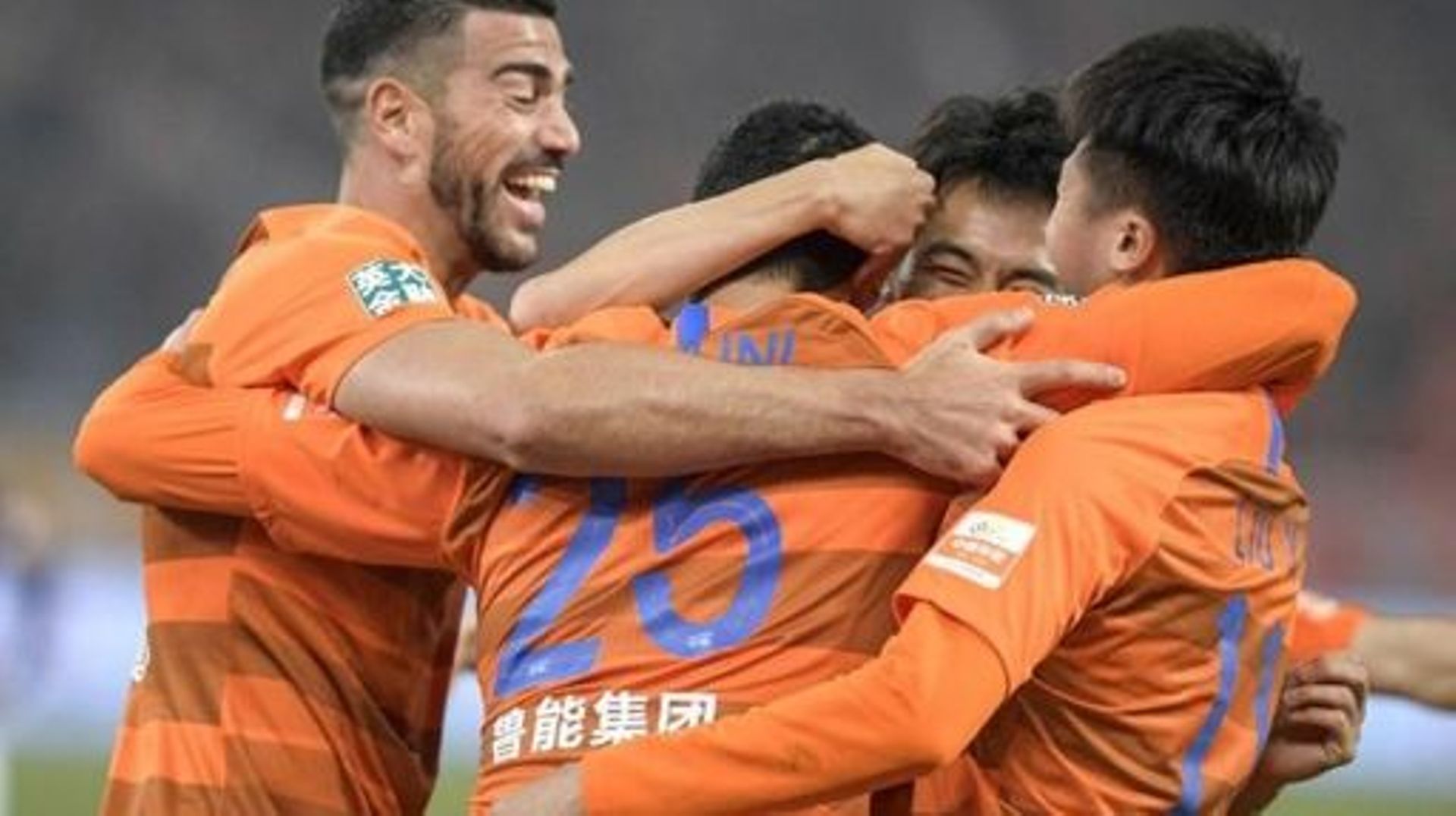 Graziano Pelle (L), Marouane Fellaini (C) and Liu Yang (R) of Shandong Luneng celebrate during the Chinese Super League (CSL) football match between Shandong Luneng and Beijing Renhe in Jinan in China's eastern Shandong province on March 1, 2019. Marouane