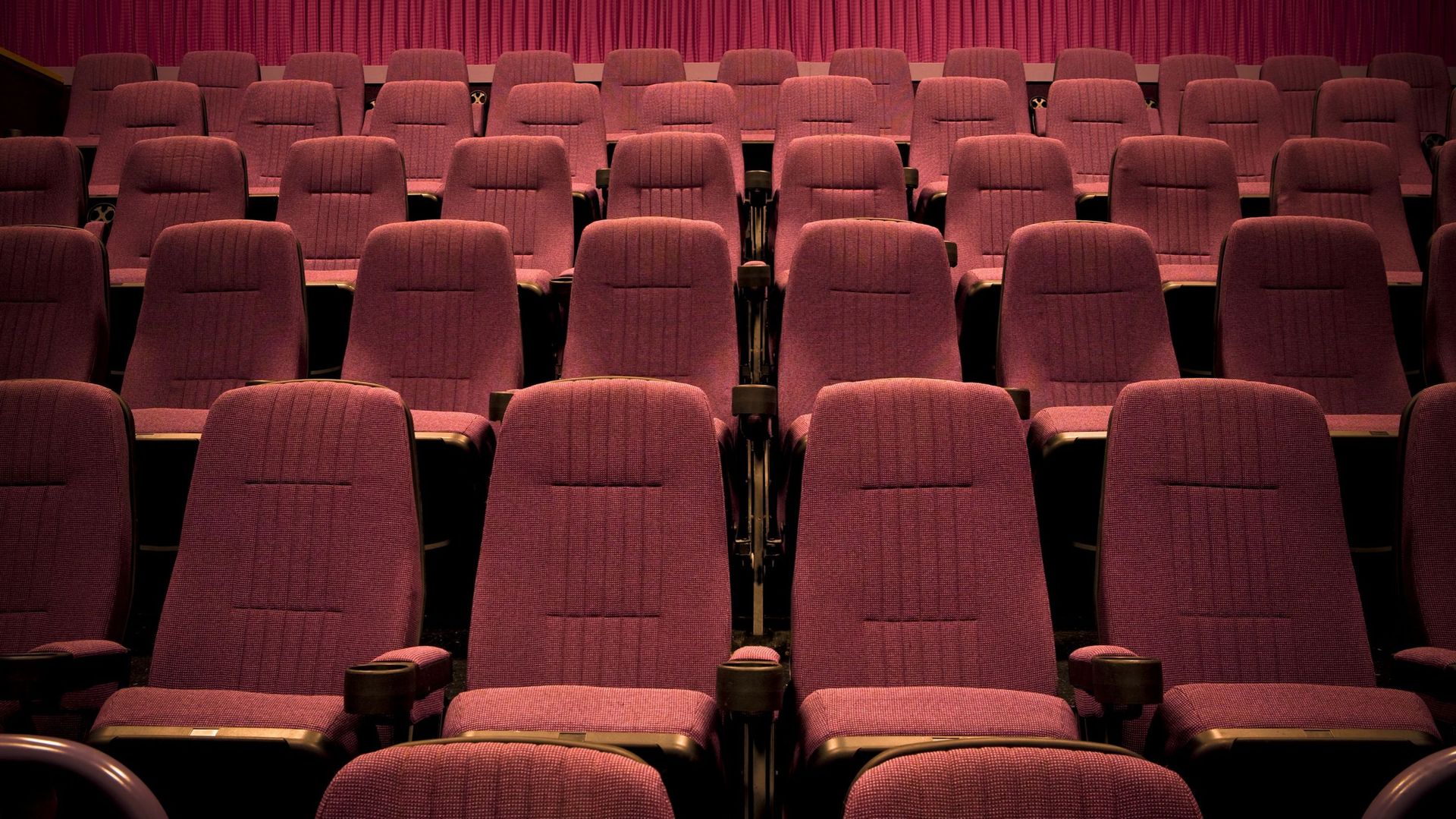 Empty chairs in movie theater.