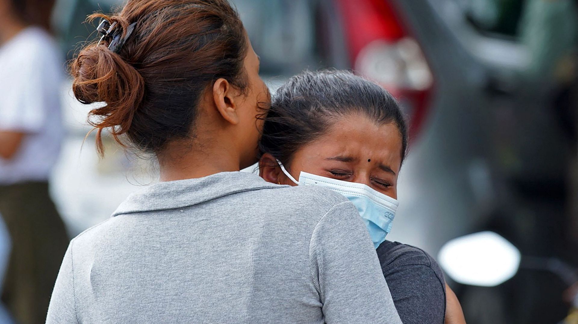 Des membres des familles et des proches des passagers à bord de l'avion Twin Otter exploité par Tara Air, pleurent devant l'aéroport de Pokhara, le 29 mai 2022. - Un avion de passagers avec 22 personnes à bord a été porté disparu au Népal le 29 mai, ont d