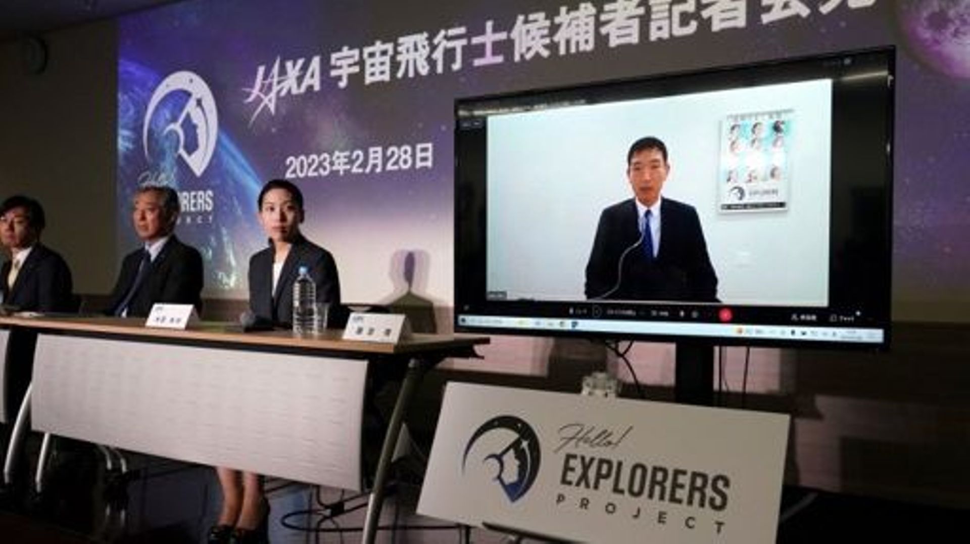 Astronaut candidates for the Japan Aerospace Exploration Agency (JAXA), Ayu Yoneda (3rd L), a surgeon at the Japanese Red Cross Medical Center, and Makoto Suwa (on screen), a disaster prevention specialist at the World Bank, attend a press conference in T