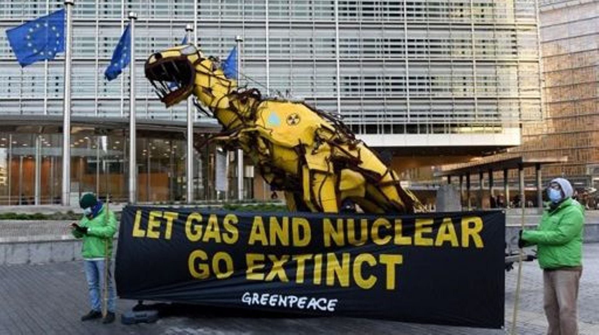 A statue depicting a giant dinosaur painted with radioactive symbols and blue gas flames is displayed by Greenpeace activists outside the European Commission headquarters in Brussels, in protest against the inclusion of fossil gas and nuclear energy in th