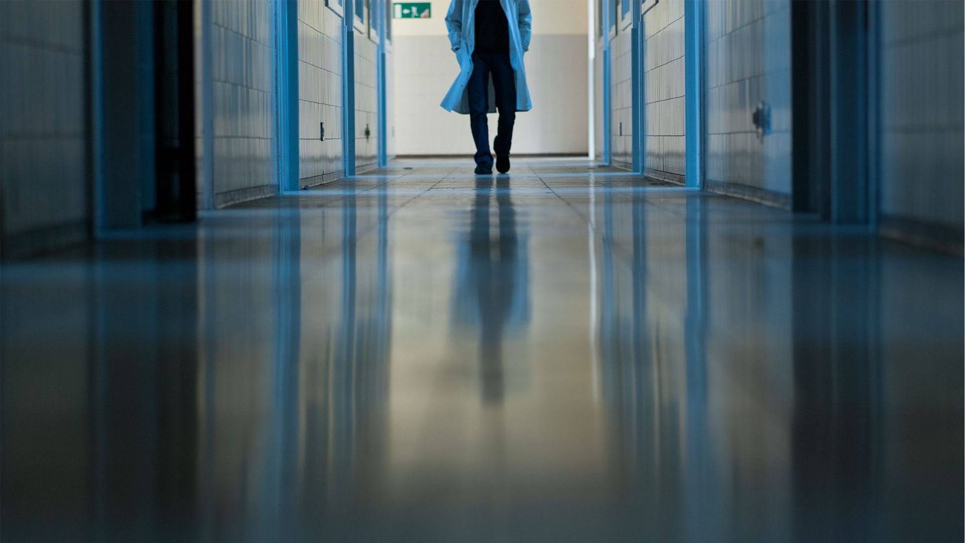 Man Doctor Walking In Hospital Corridor