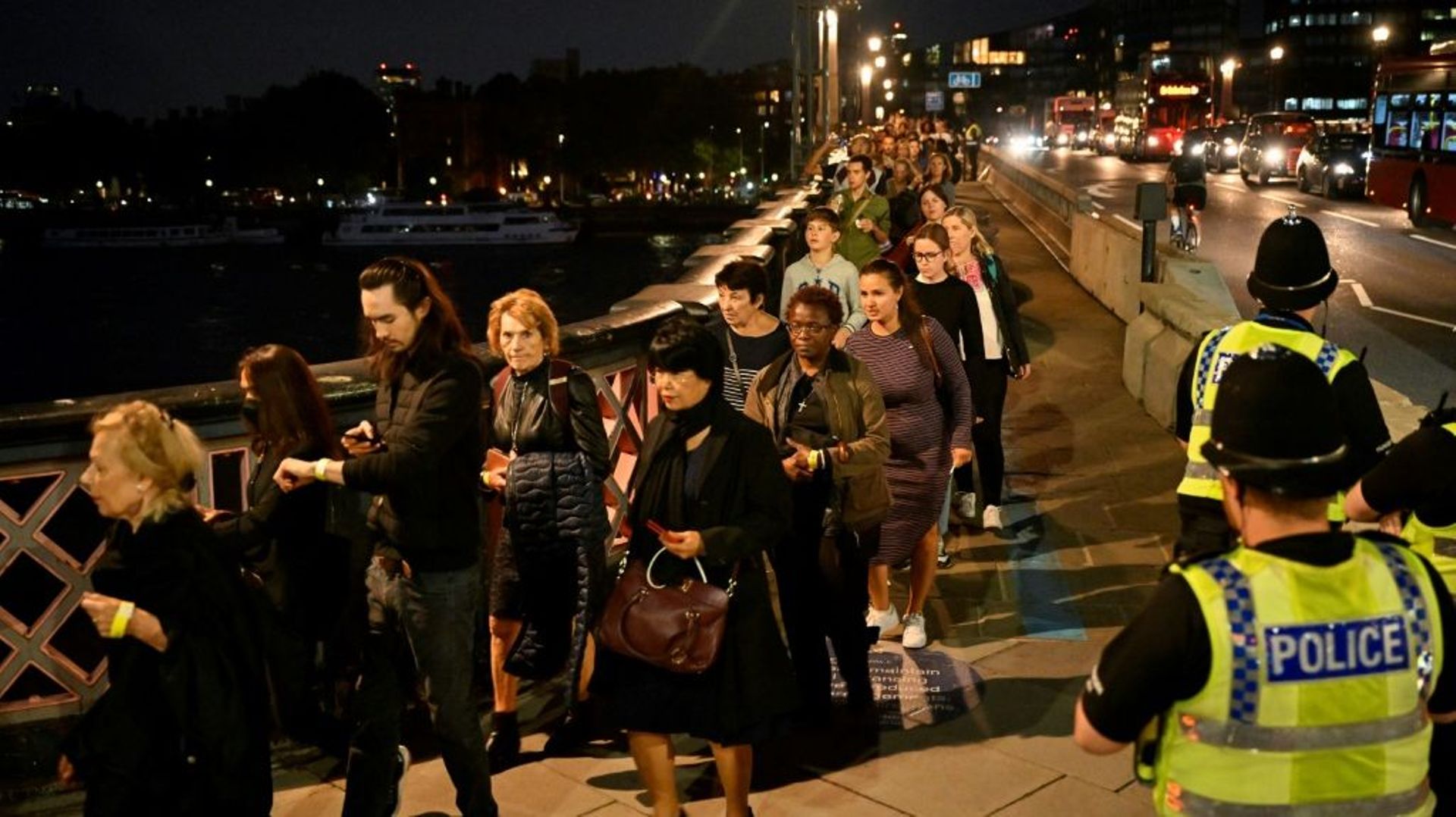 Des personnes souhaitant se recueillir devant le cercueil de la reine Elizabeth II font la queue sur le Lambeth Bridge de Londres, le 14 septembre 2022