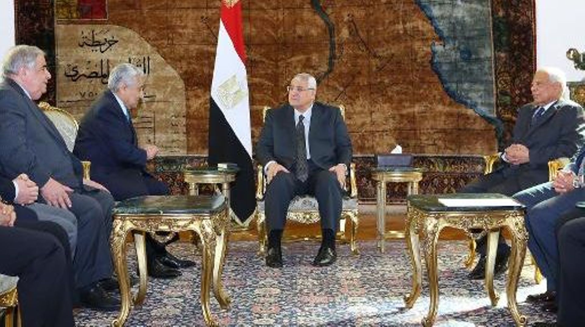 Le président égyptien par intérim Adly Mansour (C) et le Premier ministre par intérim Hazem el-Beblawi (D)