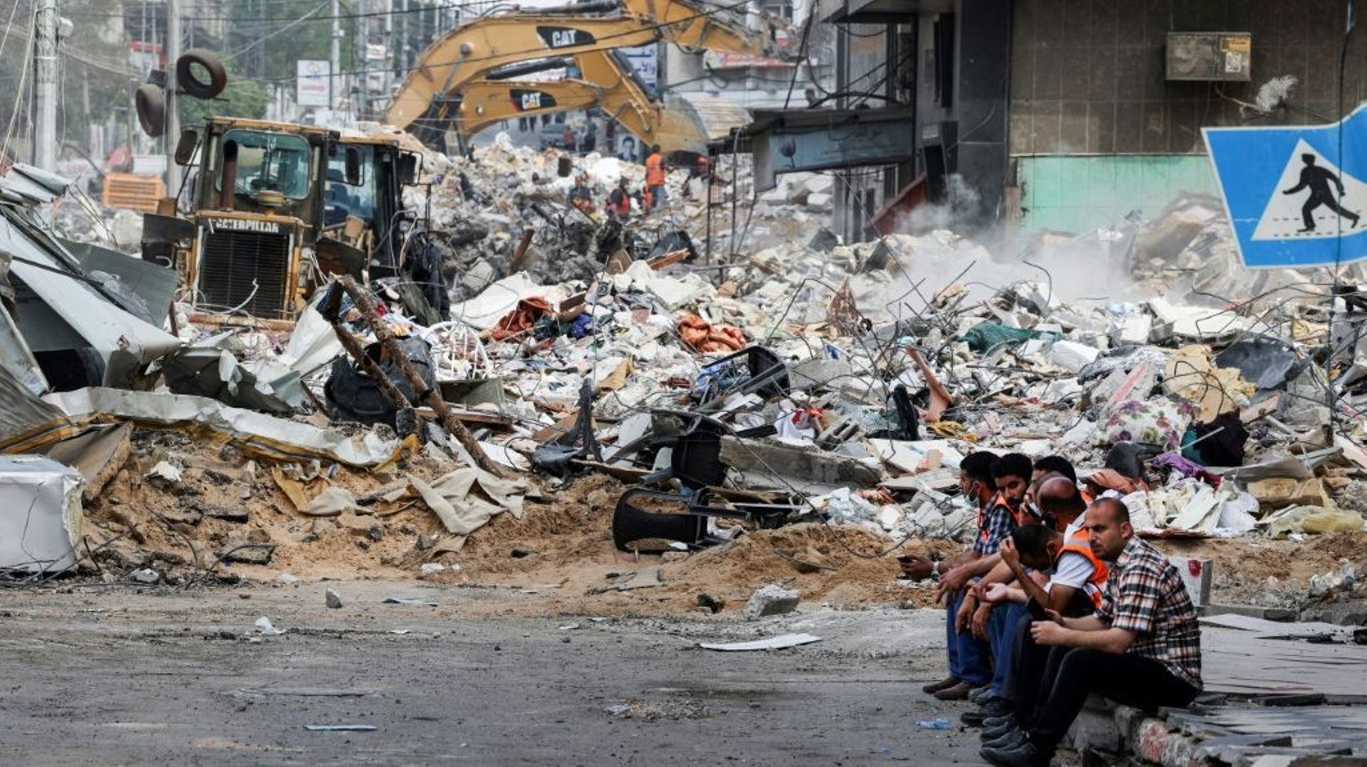 Des pelleteuses déblaient des débris dans les rues de Gaza après des bombardements israéliens, le 16 mai 2021