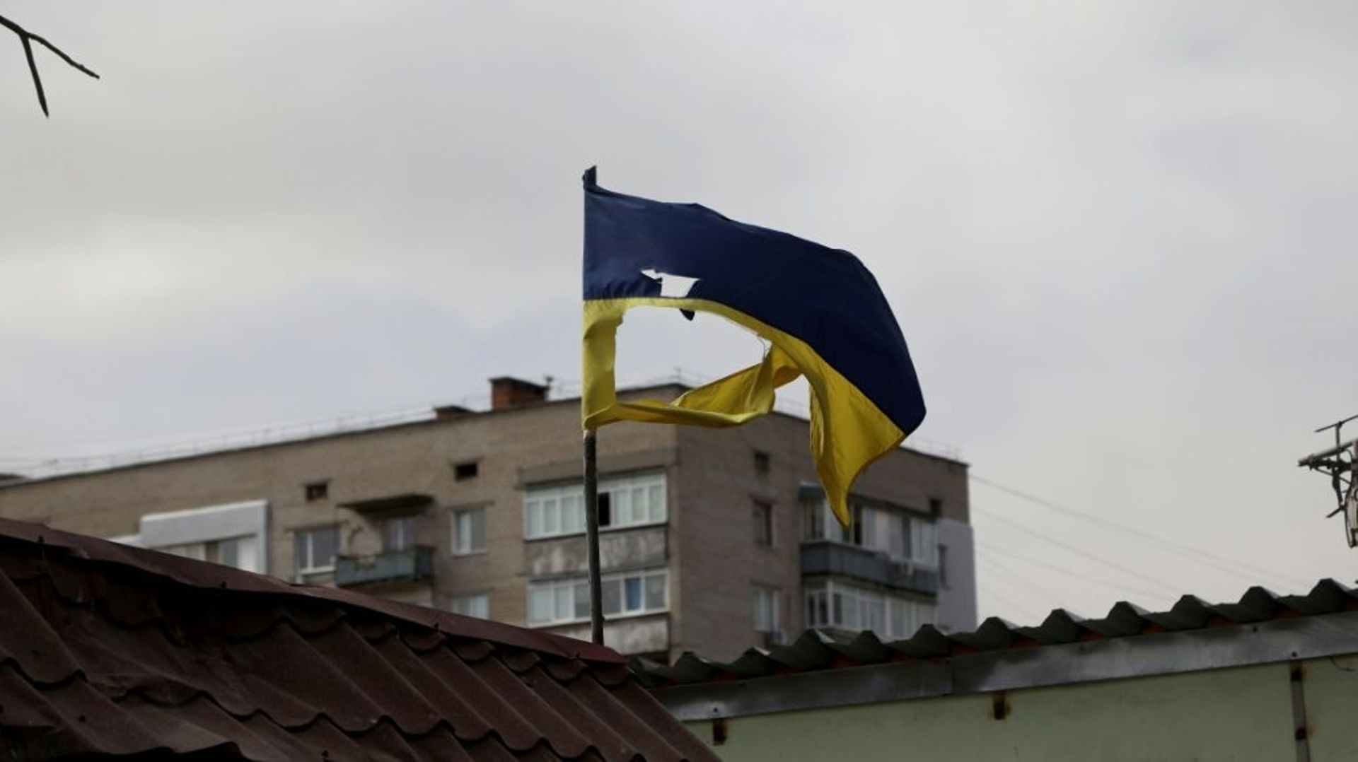 Un drapeau ukrainien déchiré est apperçu sur un bâtiment à Mykolaïv, sud de l'Ukraine, le 27 mars 2022
