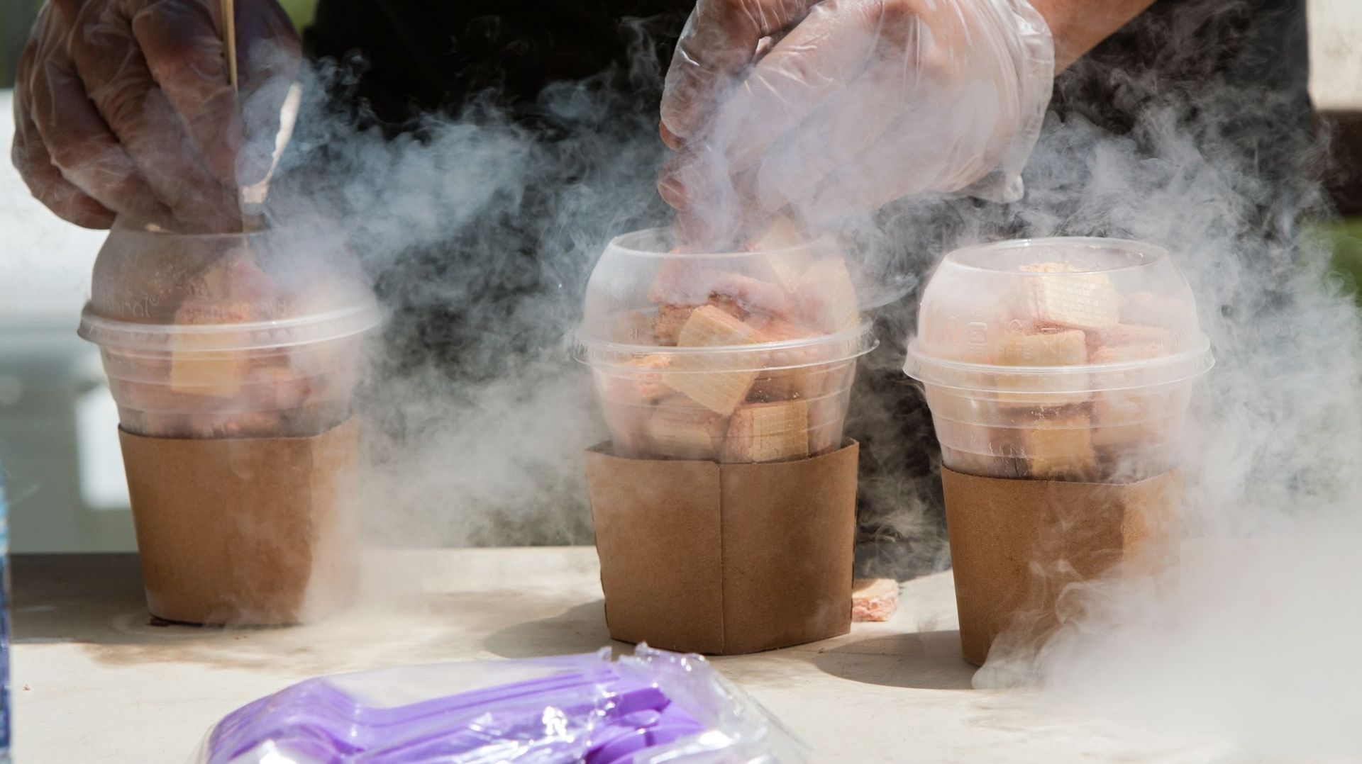 Liquid Nitrogen Steams as man prepares frozen treats at Festival Liquid Nitrogen Steams.