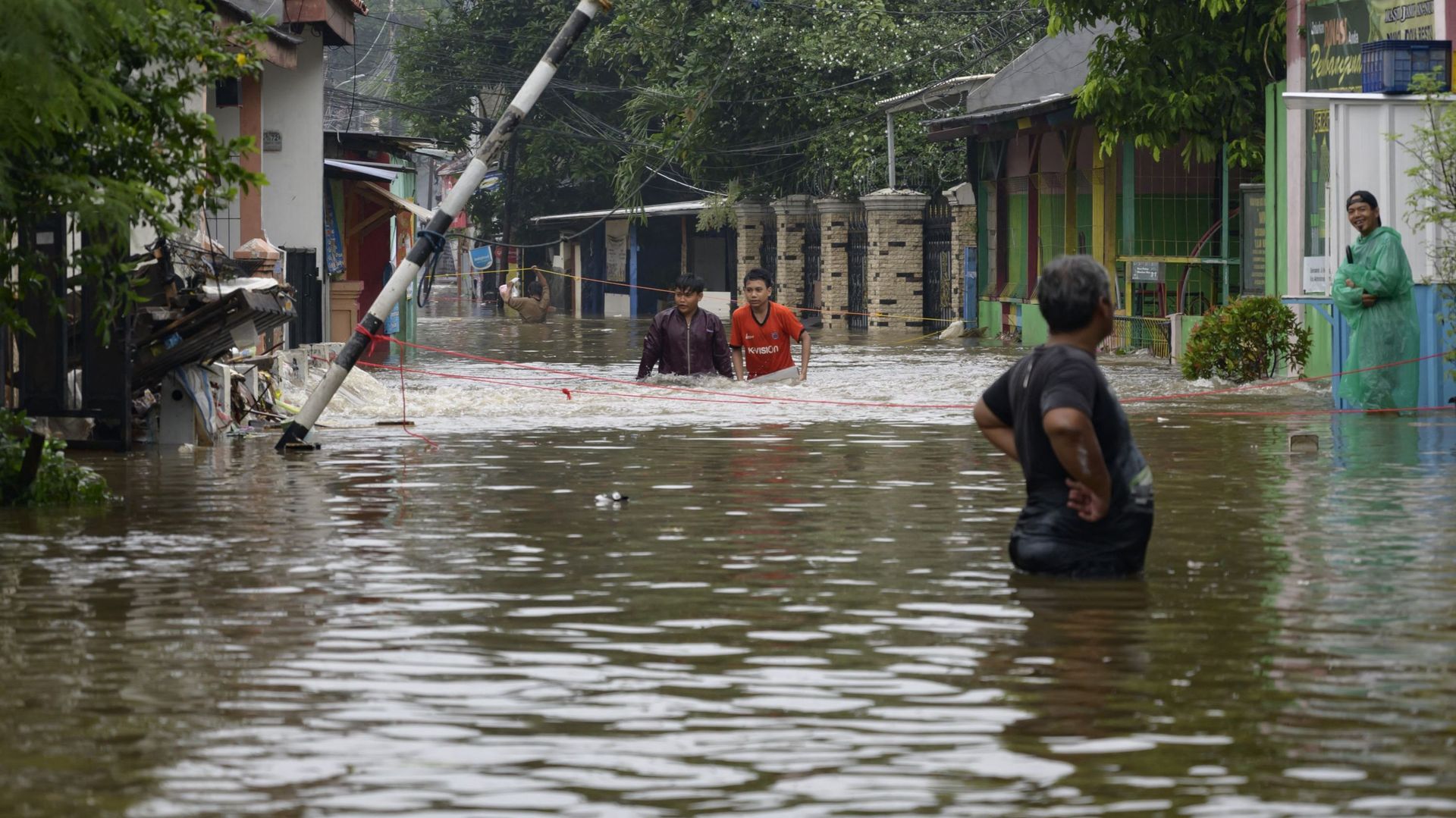 Les habitants de Jakarta tentent de se frayer leur chemin dans les rues inondées, le 20 février 2021.