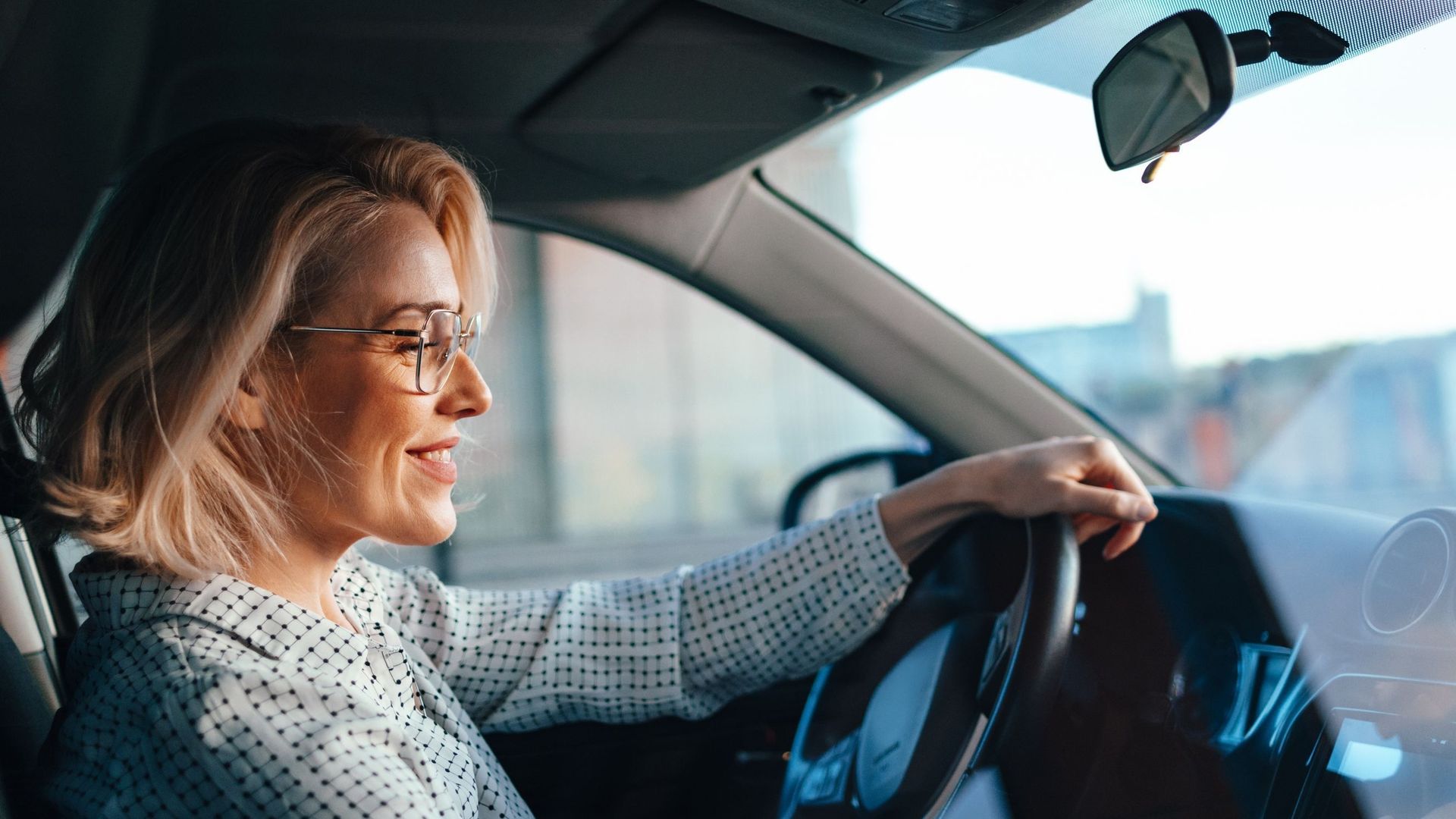 Smiling Businesswoman Driving Car